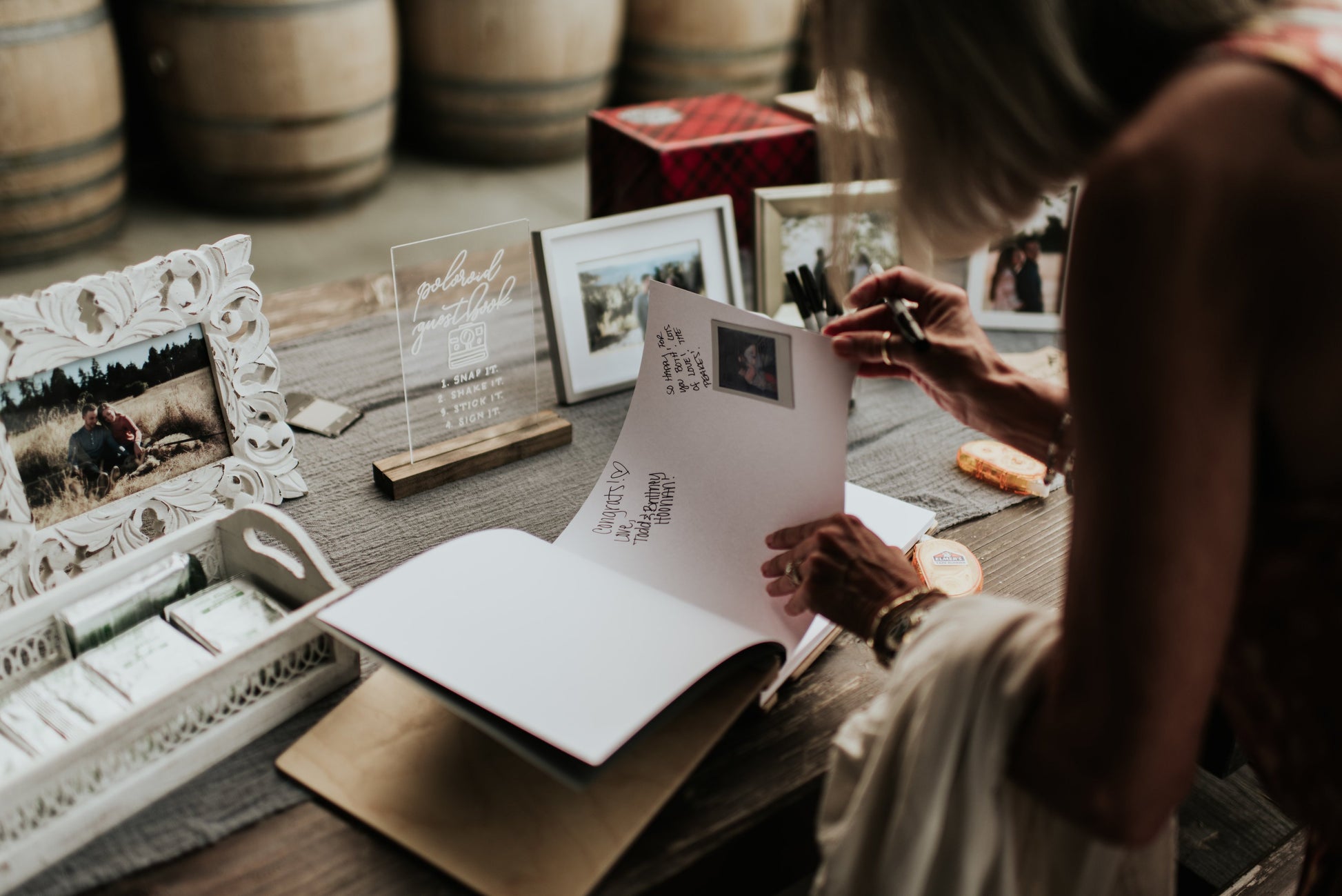 a woman sitting at a table holding a piece of paper