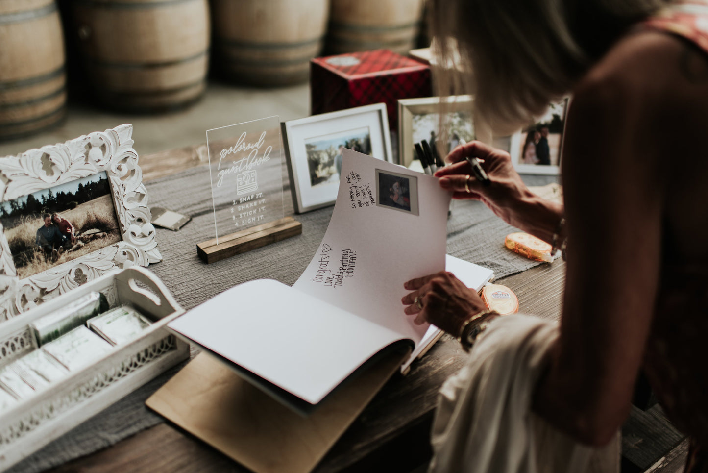 a woman sitting at a table holding a piece of paper