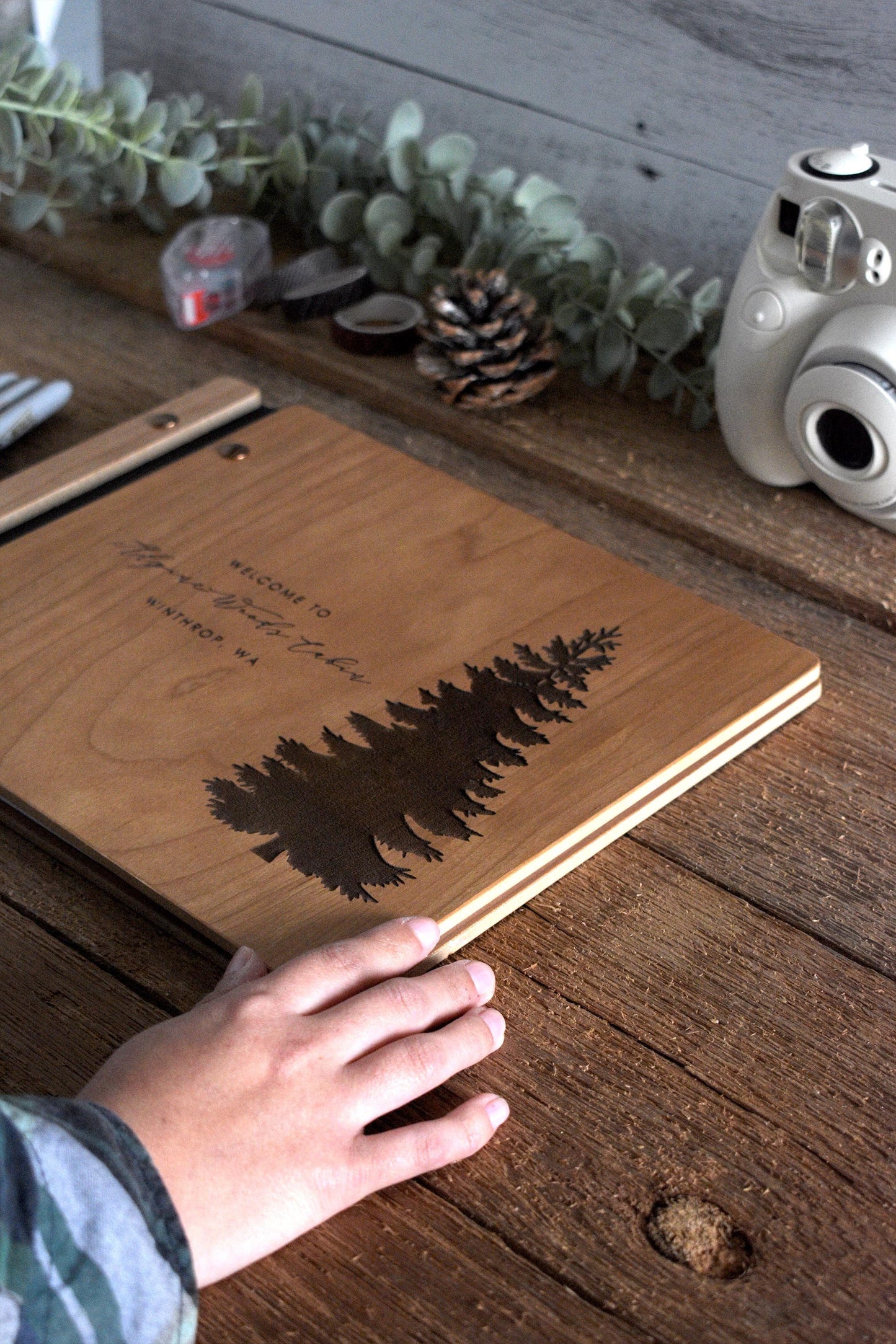 Custom Pine Tree Guestbook—perfect for Airbnbs and cabins. This book features personalized engraving on wood and captures the essence of your serene retreat.