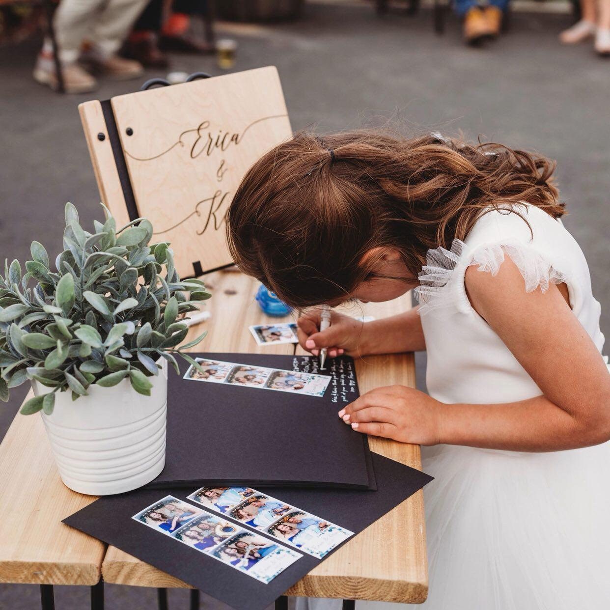 a girl in a white dress writing on a laptop