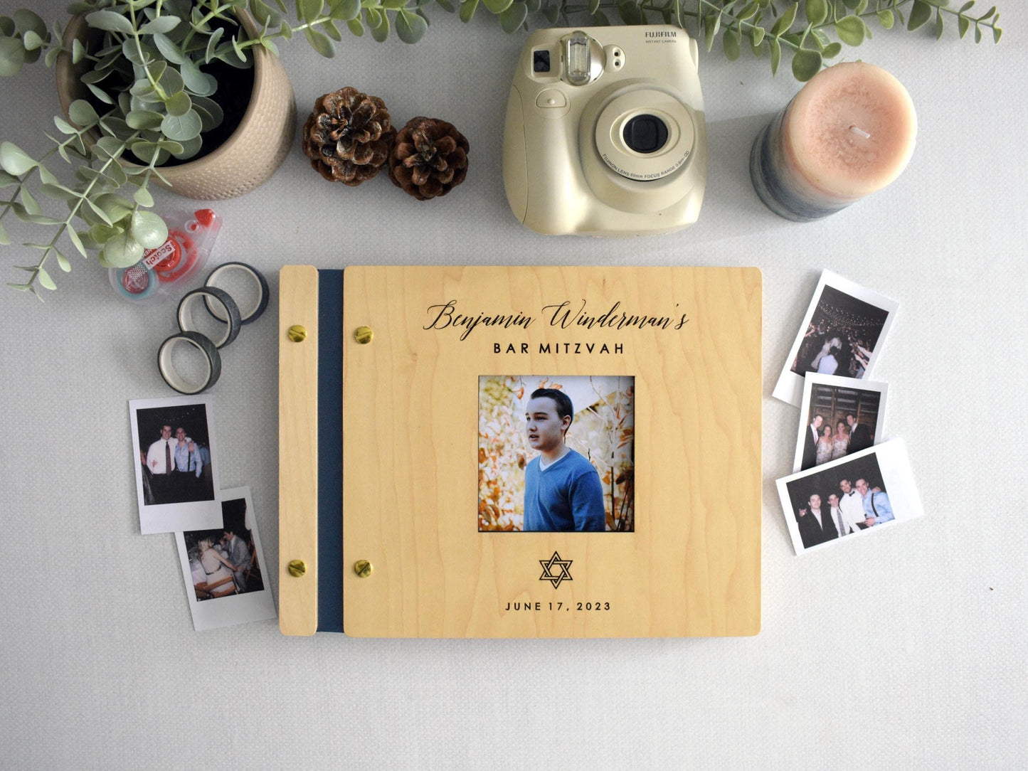 Custom Bar Mitzvah guest book featuring a photo title page and personalized details. The book is decorated with a Star of David and surrounded by Polaroid pictures, making it a perfect keepsake for capturing special memories.