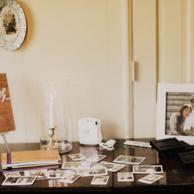 a wooden desk topped with pictures and a framed picture