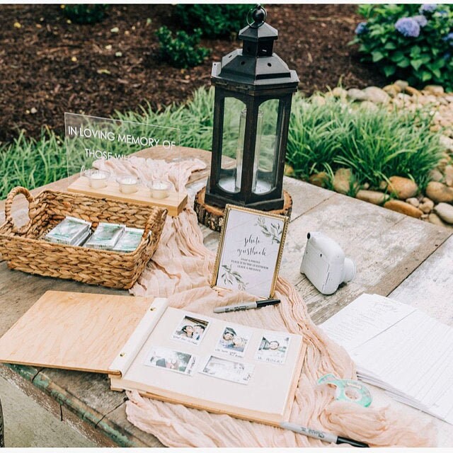 a wooden table topped with a lantern and books